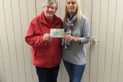 Sheila Sinton receiving a cheque from Gisela   Kerr.